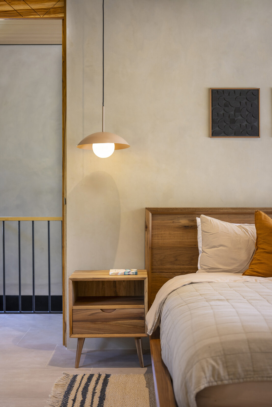 Bedroom with arched window and a citrus accent pillow
